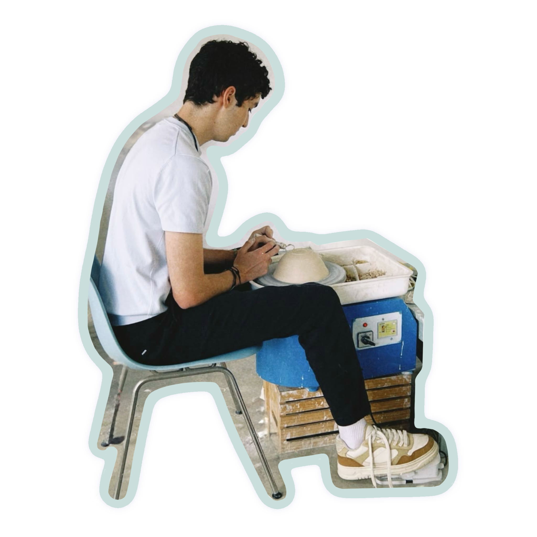 A die-cut sticker or decal showing a young man sitting on a chair at a pottery wheel, with a blue cooler and pottery visible, isolated on a white background.